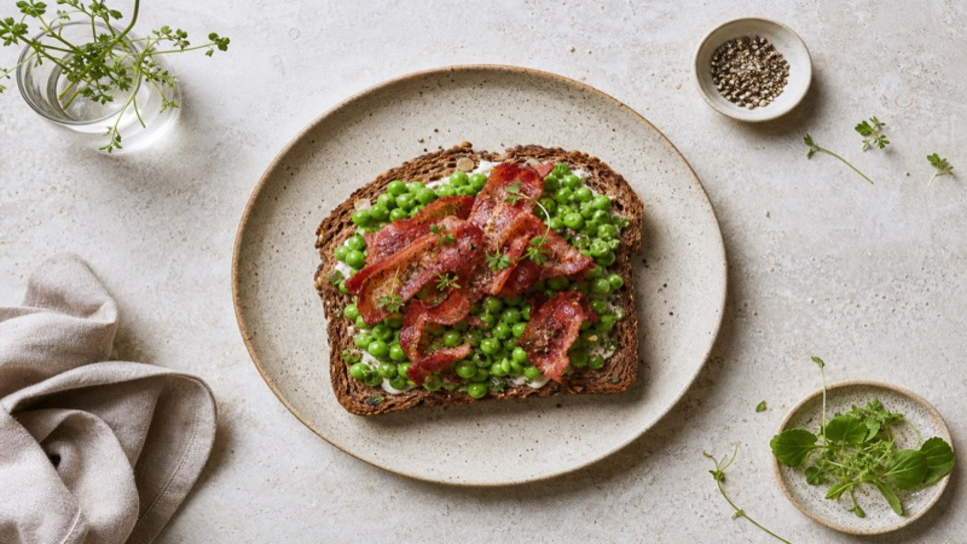 Herzhaftes Vollkornbrot mit gebratenem Speck und Erbsen
